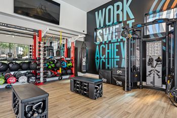 24-Hour fitness center with a cardio hub & strength training room