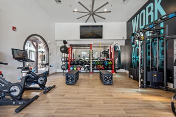 24-Hour fitness center with a cardio hub & strength training room