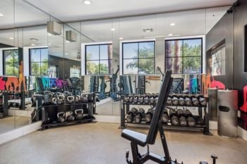 24-Hour fitness center with a cardio hub & strength training room