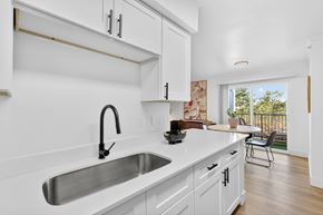 Nashville apartment for rent - A kitchen with white cabinets and a stainless steel sink.