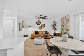 Nashville apartment for rent - A living room with a yellow couch and a white coffee table.