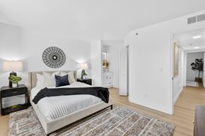 Nashville apartment for rent - A bedroom with a large bed and a round decorative item on the wall.