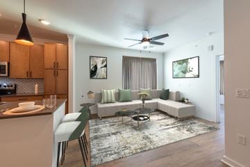 Aurora apartment for rent - A modern living room with a white couch and a coffee table.