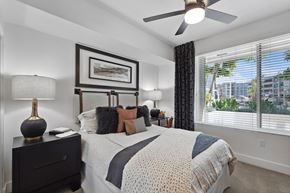 San Diego apartment for rent - a bedroom with a bed and a ceiling fan and a window