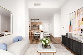 Queens apartment for rent - A modern living room with a white sofa and a coffee table.