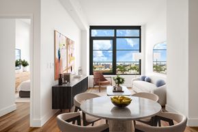Queens apartment for rent - A modern dining room with a large table and chairs.