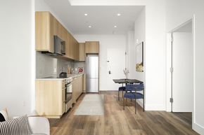 Queens apartment for rent - A modern kitchen with a dining table and chairs.