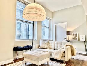 Chicago apartment for rent - a living room with a white couch and a large window