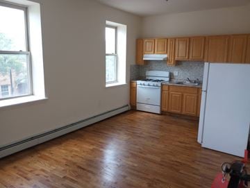 Elizabeth apartment for rent - A kitchen with wooden floors and white appliances.