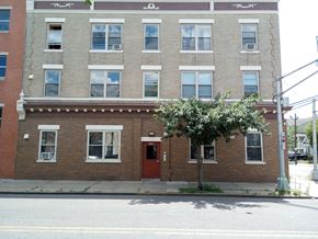Elizabeth apartment for rent - A red brick building with a tree in front of it.