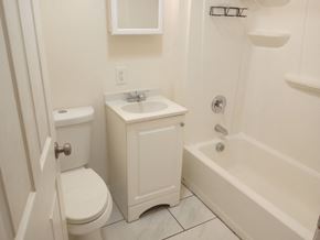 Elizabeth apartment for rent - A white bathroom with a toilet, sink, and bathtub.