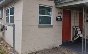 Orlando apartment for rent - A house with a red door and a sign that says 204.
