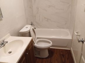 Orlando apartment for rent - A white toilet sits next to a white sink in a bathroom.