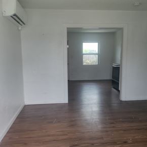Orlando apartment for rent - A room with a wooden floor and a window.