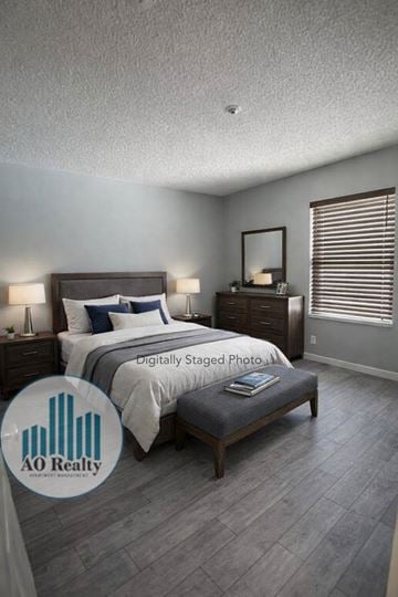Rohnert Park apartment for rent - A bedroom with a bed, nightstand, and a mirror on the wall.
