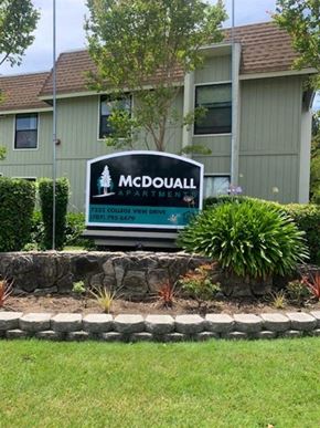 Rohnert Park apartment for rent - A McDouall apartments sign in front of a building.