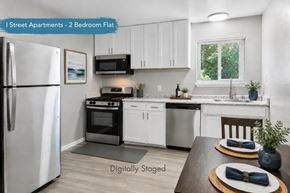 Davis apartment for rent - A kitchen with a refrigerator, stove, and sink.