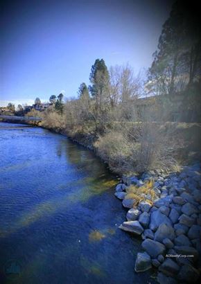 Reno apartment for rent - A river flows through a rocky landscape with trees in the background.