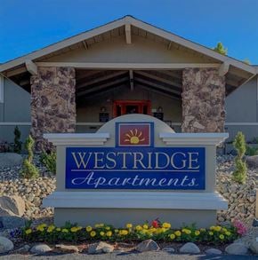 Reno apartment for rent - A sign for Westridge Apartments is displayed in front of a building.