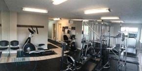 Reno apartment for rent - A gym with a variety of equipment including treadmills, weights, and exercise machines.