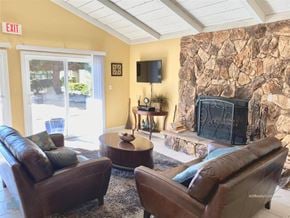 Reno apartment for rent - A living room with a stone wall and a fireplace.
