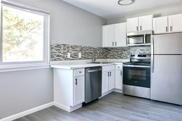 Davis apartment for rent - A kitchen with white cabinets and stainless steel appliances.