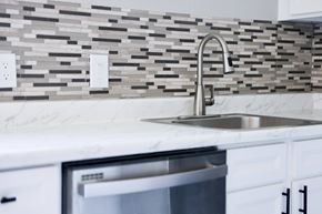 Davis apartment for rent - A modern kitchen with a marble countertop and a stainless steel sink.
