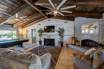 Redding apartment for rent - A living room with a pool table and a fireplace.
