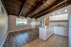 Redding apartment for rent - A kitchen with white cabinets and a wooden ceiling.