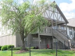 Knoxville apartment for rent - A tree in front of a building with a fence around it.