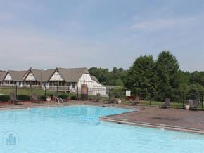 Knoxville apartment for rent - A pool with a fence and a building in the background.