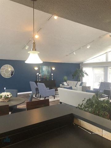 Knoxville apartment for rent - A living room with a grey couch and a white table.