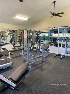 Knoxville apartment for rent - A gym with a variety of equipment including weights and a bench.