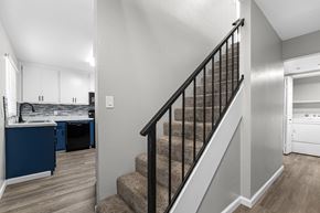 Chico apartment for rent - Staircase with black railing and carpeted steps at Pomona Townhomes Apartments, Chico, 95928