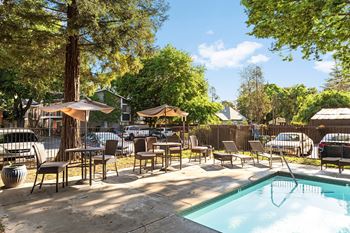 Hot tub with patio seating and umbrellas