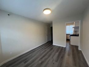 San Francisco apartment for rent - A room with a light on the ceiling and a doorway leading to another room.