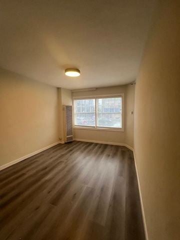 San Francisco apartment for rent - A room with a window and wooden flooring.