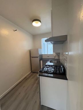 San Francisco apartment for rent - A small kitchen with a refrigerator, stove, and oven.