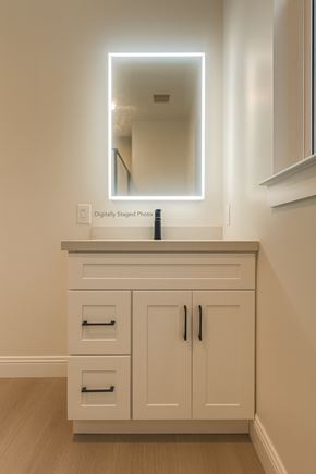 San Francisco apartment for rent - A white cabinet with a mirror above it and a bottle of lotion on the counter.