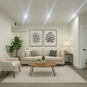 San Francisco apartment for rent - A living room with a couch, chair, and two framed pictures on the wall.