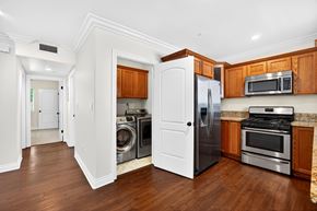 Los Angeles apartment for rent - A kitchen with a white refrigerator, stove, and microwave.
