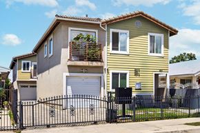 Los Angeles apartment for rent - A yellow house with a black gate in front.
