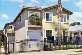Los Angeles apartment for rent - A yellow house with a black gate in front.