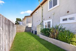 Los Angeles apartment for rent - A house with a green lawn and a wooden fence.