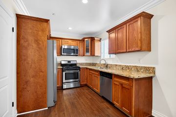 Los Angeles apartment for rent - A kitchen with wooden cabinets and a granite countertop.