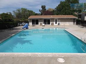 Chico apartment for rent - A pool with a blue cover and a house in the background.