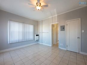 Los Angeles apartment for rent - A room with a ceiling fan and a window with blinds.