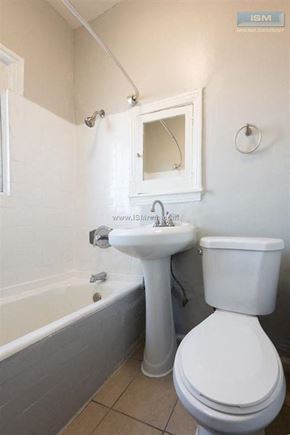 Los Angeles apartment for rent - A white toilet sits next to a sink in a bathroom.