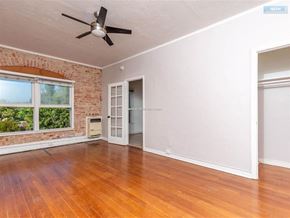 Los Angeles apartment for rent - A room with a ceiling fan and a brick wall.