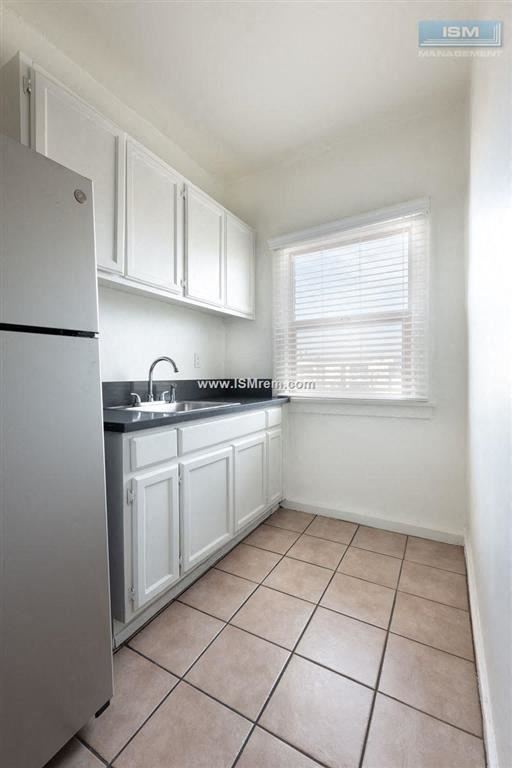 Los Angeles apartment for rent - A kitchen with white cabinets and a tiled floor.